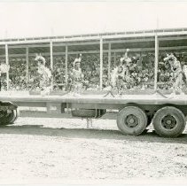 Black and white print of Native dancers on a platform