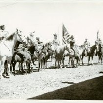 Black and white print of several men and women on horseback; flags visible