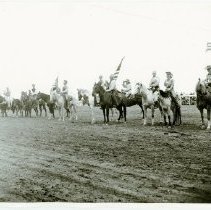 Black and white print of several men and women on horseback