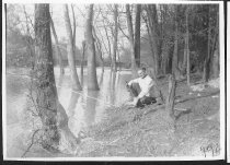 Man fishing by floodedarea.  1944