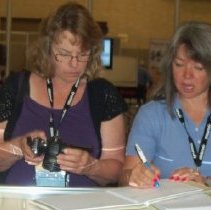 Jackie Jones and guest working the APCO historical booth.