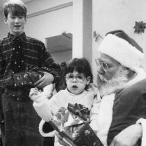 33.Chestnut Hill Academy student Chris Shea helps Santa distribute gifts...
