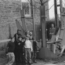 43.Two women with six lower school boys near a crane at the school