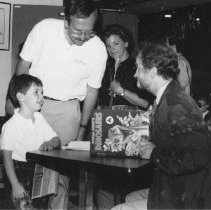 57.Dougal Dixon, a Scottish dinosaur authority, signs copy of his book