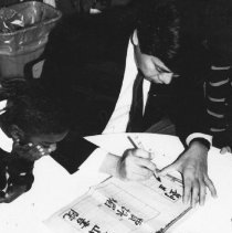 61.The Rev. Timothy Fong teaches calligraphy to kindergarteners