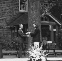 72.Head of school Richard Parker congratulates senior Eric Foster Keebler