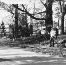 9.Unidentified man rakes leaves near CHA's entrance