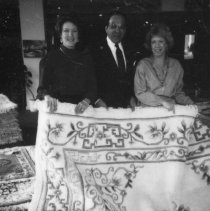 18.Looking at a rug being donated for auction