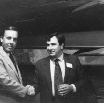 43.Thomas R. White, congratulates Clifford Swain