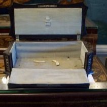 Glove box with front flap down and broken feet