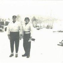 02.10 Pecketts, man and woman standing in a snow covered lot, 1941.