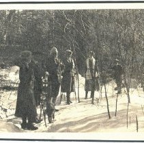 03.08 Pecketts, people and dog along a snowcovered trail, holding snowshoes