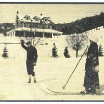 03.05 Pecketts, "Phil" and woman on skiis in front of the inn, 1915