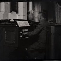 Man playing organ negative by George Meeres