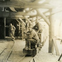 Kootenay Belle Gold Mines miners riding an underground train
