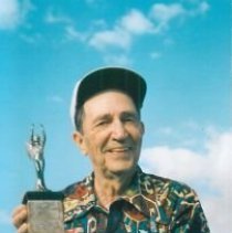 Elmer Wasman posing with his 1937 3rd place RC trophy for the White Mystery