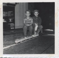 Two Boys in Engineer's Caps with Toy Train