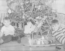Two Boys in Front of Christmas Treewith Train Set & Erector Set
