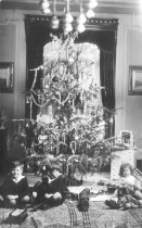 Twins Under Christmas Tree w. Toy Trains and Sister