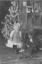 Two Children w. Toy Train, Game and Bear in Stocking