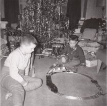 Twl Boys Play with Train Set Under Christmas Tree