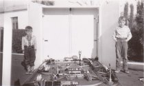 Two Boys Standing beside Large Platform Layout.