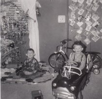 Two Boys with Toy Train Set and Ride-On Car