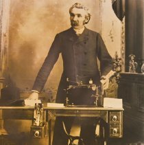 Portrait of M.W. Simkins with a Sewing Machine