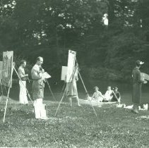 Painters by pond with boaters