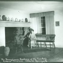 Woman by colonial fireplace