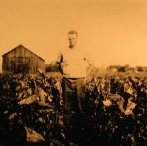 Watson Vibert standing in a field at Vibert Farm