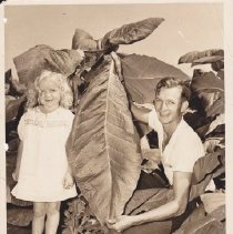 Charles C. Griffin and daughter Jane with tobacco leaf on Griffin Farm
