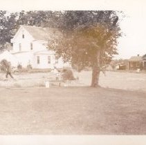 Grant Farm foreman's house with people moving hay