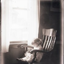 Unidentified young girl by a window