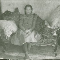 Mary Jennings on a loveseat