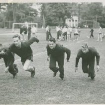 Four male students in a sprint race