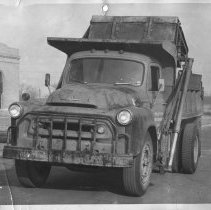 Northeast. [Water Dept. dump truck with arm possibly lifting bin to dump bar screenings?]