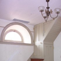 Northeast corner of interior of Caretaker's House showing enclosed stairs to second floor.