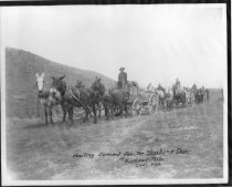Freight wagons with loads of cement. "Hauling Cement for the Shoshone Dam."