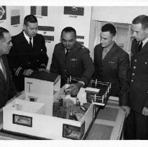 Spanish language students practice using a model house, 1965.