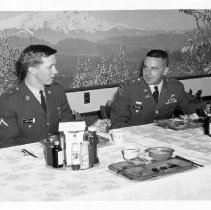 Carlson and Mulvaney eating, 10,000th Russian Graduate, 6 April 1967