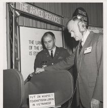 DLIWC: Captain D.H. Heins and the Honorable Stanley Resor using headphones during the Association of US Army meeting