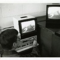 Fort Ord -soldier monitoring weather on TV