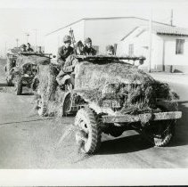 Fort Ord - 147th field artillery driving in camouflage vehicles