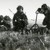 Fort Ord -field maneuvers: soldiers looking through a sight