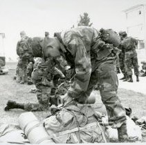 Fort Ord -field maneuvers: soldier packing bag