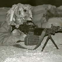 Fort Ord -field maneuvers: soldier firing machine gun