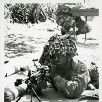 Fort Ord -field maneuvers: Soldier aiming machine gun