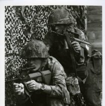 Fort Ord -field maneuvers: soldiers aiming machine guns