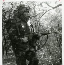 Fort Ord -field maneuvers: soldier walking with machine gun